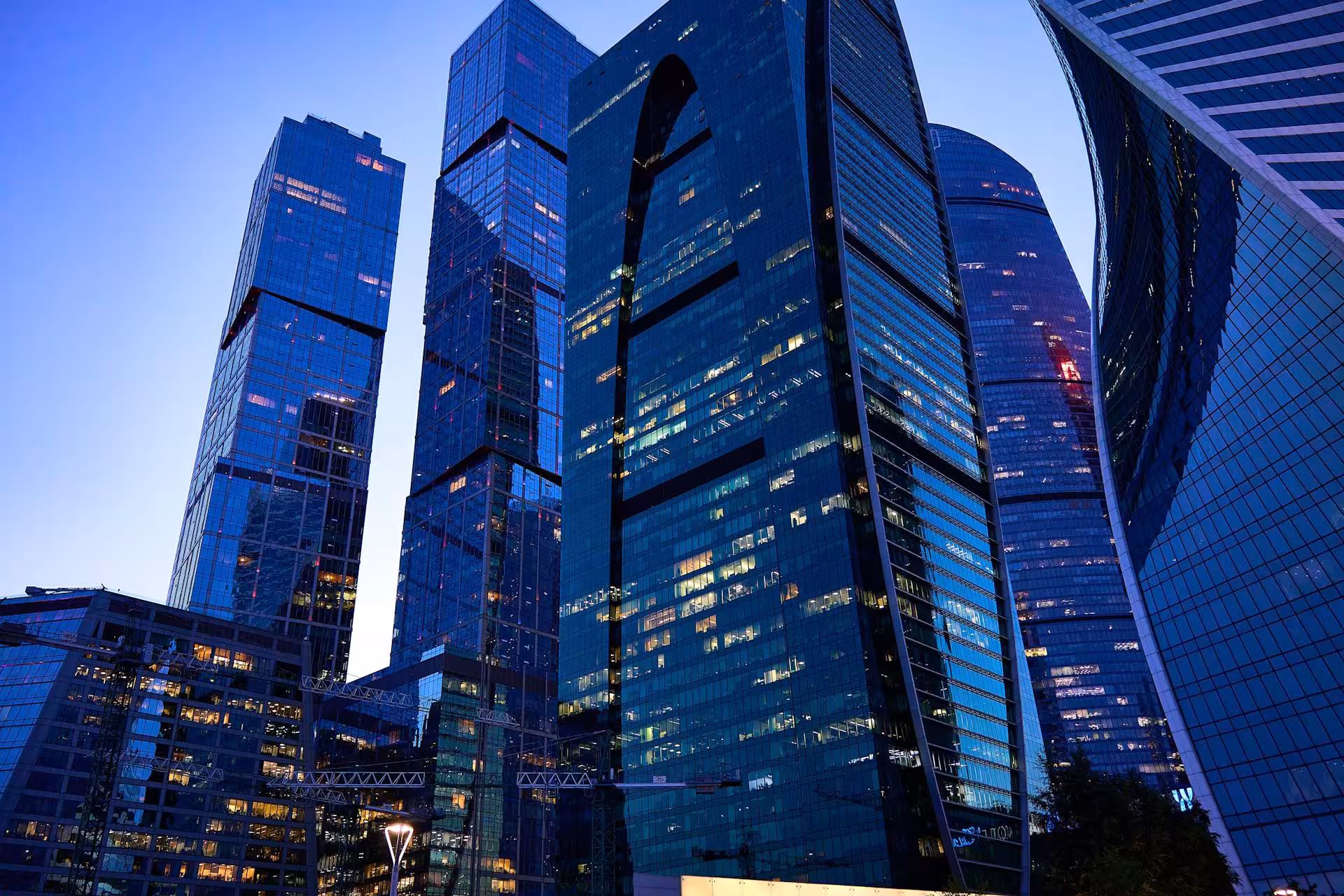 Blue glass financial district towers at dusk